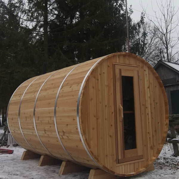Outdoor sauna crafted from knotty cedar, round barrel design with porch area