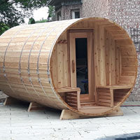 Traditional round barrel sauna in cedar wood with rustic porch design