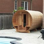 Handcrafted cedar barrel sauna designed for backyard wellness retreat.
