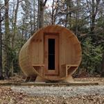 Front view of cedar barrel sauna with wooden door and knotty cedar build